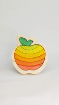 Puzzle de madera en forma de manzana en degradado